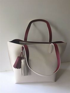 NWT Kate Spade Foster Court Tasha Leather Tote Handbag WKRU3832 Ivory $399 NEW Style: Foster Court Tasha Style #: WKRU3832 Dimension: 17" L x 13" H x 6" D Color: Pebble/Dark Red Material: Genuine Leather You are looking at a brand new Foster Court Tasha Leather Tote by KATE SPADE. This beautiful handbag is BRAND NEW and 100% AUTHENTIC. Features: Pebbled leather Polished 14K light gold hardware Double handles with 9" drop     Open top with two leather fringe tassels  Interior leather color: dark Luxury White Shoulder Bag With Large Capacity, White Luxury Large Capacity Shoulder Bag, Luxury White Large Capacity Shoulder Bag, Luxury Large Capacity White Shoulder Bag, White Bucket Bag With Detachable Handle, White Tote Bucket Bag With Detachable Handle, White Bucket Bag Tote With Detachable Handle, White Tote Bucket Bag For Shopping, Cream Handheld Shoulder Bag For On-the-go