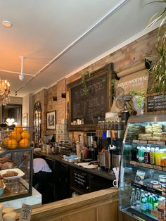 the interior of a coffee shop with lots of counter space and food items on display