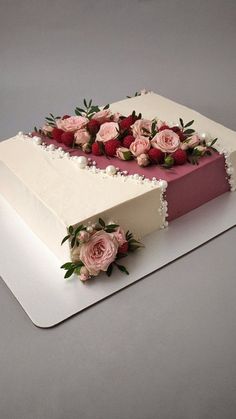 a large white cake with pink flowers on top