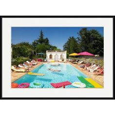 an outdoor swimming pool with lounge chairs and umbrellas