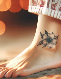 a woman's foot with a flower tattoo on it