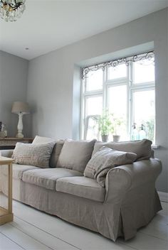 a living room filled with furniture and a chandelier