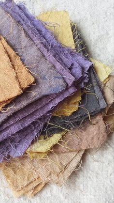 a pile of different colored pieces of cloth