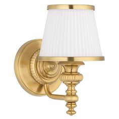 a gold wall light with a white shade on the top and bottom half of it