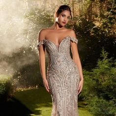 This Breathtaking Off-The-Shoulder Gown, Adorned With Linear Silver Crystal Beading And A Nude Hue, Creates An Ethereal Canvas That Shimmers With Every Movement. The Deep Sweetheart Neckline Adds A Touch Of Allure, Framing Your Silhouette With Timeless Elegance. Length: Long Color: Dusty Mauve Neckline: Deep Sweetheart Neck Silhouette: Sheath Sleeve: Sleeveless Back: Semi-Open, Zipper Embellishments: Beads Occasion: Romantic Date/Evening/Dinner, Wedding/Bridesmaid, Graduation, Fashion Show, Visi White And Gold Evening Gown, Mom Quince Dress, Great Gabsty Prom Dresses, Winning Pageant Gowns Miss Usa, Mom Of Quinceanera Dress, Mother Of The Quinceanera Dresses, Sparkly Evening Dress, Silver Formal Dress, Museum Restaurant