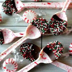 spoons filled with candy canes and sprinkles on top of each other