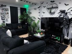 a living room filled with black furniture and lots of bats on the wall above it