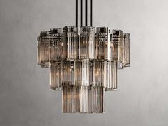 a chandelier made out of glass tubes hanging from a ceiling in a room