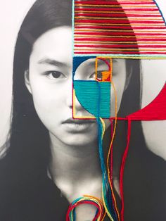 a woman's face is surrounded by multicolored lines and shapes, including a square shaped object