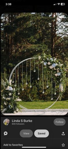 the wedding arch is decorated with white flowers and greenery for an outdoor ceremony at linda s burke