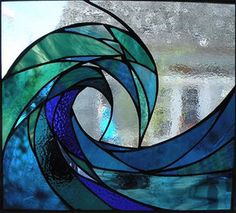 a stained glass window with blue and green swirls