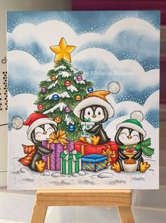 a christmas card with penguins holding presents under a tree