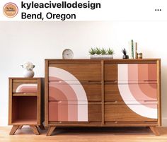 a wooden dresser sitting on top of a hard wood floor next to a white wall