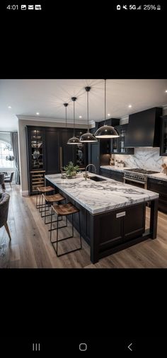 an image of a kitchen setting with marble counter tops and island seating area in the middle