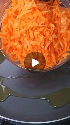 carrots being cooked in a bowl on top of an electric burner with the words, how to cook shredded carrots