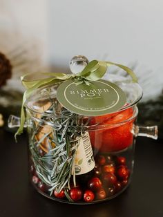 a glass jar filled with berries and spices