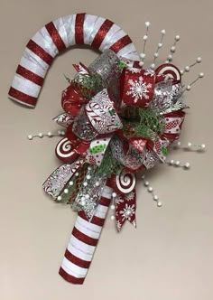 a candy cane decorated with christmas decorations