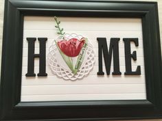 there is a sign that says home with a tulip on it