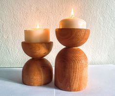 two wooden candles sitting on top of each other