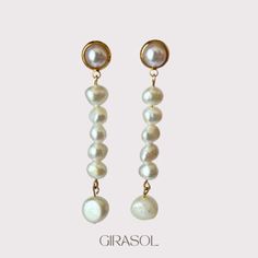 Step into elegance with our "Lorelai" Gold Plated Drop Earrings, adorned with natural pearls. These exquisite earrings are a testament to timeless beauty and sophisticated craftsmanship, perfect for adding a touch of luxury to any occasion. Crafted from high-quality gold plated metal, each earring features a delicate drop design that accentuates the natural luster and uniqueness of the pearls. The pearls, known for their organic shapes and iridescent hues, complement the warm gold finish beautifully, creating a harmonious blend of classic and contemporary styles. The "Lorelai" earrings are designed to capture attention with their graceful silhouette and subtle shimmer. Whether worn with an evening gown or paired with everyday attire, they effortlessly elevate your look with their understat Pearl White Bridal Earrings With Pearl Chain, Pearl White Akoya Pearl Drop Bridal Earrings, Pearl Chain Earrings For Anniversary, Anniversary Pearl Earrings With Pearl Chain, Graceful White Pearl Charm Earrings, Graceful White Pearl Earrings With Charm, Pearl White Pearl Chain Earrings For Anniversary, Pearl White Pearl Drop Bridal Earrings, Bridal Pearl Drop Earrings In Pearl White