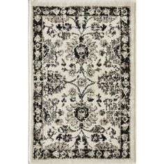 an area rug with black and white designs on the bottom, in front of a white background