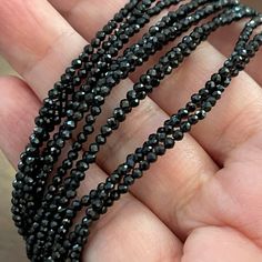 This Is An Absolutely Gorgeous 3-Strand Faceted Black Spinel Bead Sterling Silver Necklace. The Beads Are 2.0 To 2.5 Mm In Diameter. It Measures 34 Inches Long And Can Be Worn As A Long 3-Strand Or A Shorter 6-Strand Necklace. The Clasp And The 2.0 Inch Extender Chain Are Made Of Sterling Silver And Stamped 925 On The Catch Of The Clasp. It Is Also Stamped Bbj For The Manufacturer’s Mark. In Unused Vintage Condition. Elegant Black Rondelle Beaded Necklaces, Elegant Black Beaded Bracelets With Silver Beads, Black Rondelle Beaded Necklaces, Black Beaded Rondelle Necklace, Black Faceted Beaded Necklaces For Party, Black Beaded Rondelle Jewelry, Black Rondelle Spacer Beads Jewelry, Black Double Strand Faceted Beads Jewelry, Formal Black Multi-strand Beaded Necklaces