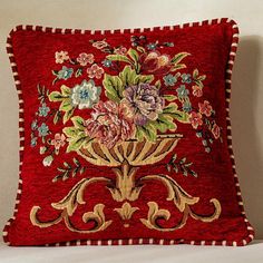 a red pillow with flowers on it