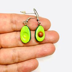 Get ready to swoon over these cute and charming earrings shaped like avocados! Handmade with care by skilled artisans, these clay beauties are out of this world. They're sure to turn heads and add a touch of chic to your outfit. These Mexican earrings offer a mix of traditional and modern styles, perfect for those looking for something one-of-a-kind. Get your hands on some CLAYWELRY™ and experience the joy of wearing something truly special. MATERIAL(S): All our earrings are created using natura Adventure Time Clay Earrings, Adjustable Novelty Single Earring Jewelry, Teardrop Polymer Clay Jewelry For Gifts, Teardrop Polymer Clay Jewelry As A Gift, Hypoallergenic Clay Jewelry For Gifts, Hypoallergenic Clay Jewelry As A Gift, Green Handmade Novelty Earrings, Handmade Green Novelty Earrings, Novelty Hypoallergenic Polymer Clay Jewelry