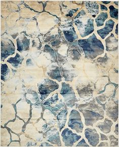 a blue and beige rug with an abstract design