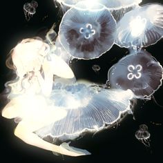 a woman sitting under jellyfish in the ocean