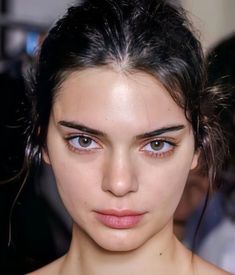 a close up of a woman with blue eyes