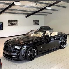 a black convertible car parked in a garage