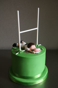 a green cake with a soccer goal on top