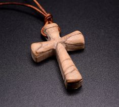 Introducing the Handmade Evergreen Wooden Cross Necklace, a timeless and meaningful piece designed for those seeking style and spirituality. Crafted from high-quality wood, this men's cross necklace exudes a minimalist, yet bold look. Perfect for daily wear, the dark wood finish enhances its rugged appeal, while the comfortable chain ensures ease. Whether for casual outings or meaningful moments, this cross necklace for men offers both a modern aesthetic and spiritual significance. Embrace the blend of tradition and craftsmanship with this unique wooden cross pendant. Specifications Material Olive Wood Color Natural length 1.5" / 4.0 cm Width 1" / 2.5 cm WARNING: CHOKING HAZARD -- Small parts. Not for children under 3 yrs. Wooden Cross Necklace, Cross Necklace For Men, Cross Jewelry Necklace, Wooden Watches For Men, Mens Cross Necklace, Clock Gift, Mens Crosses, Wooden Necklace, Wooden Cross