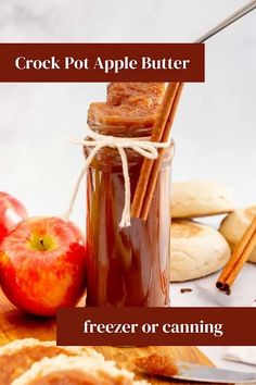 an apple butter is in a jar with cinnamon sticks