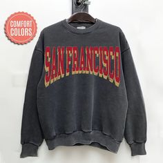 "comfort colors San Francisco Football sweatshirt, San Francisco Football Shirt, San Francisco Football Gift -Please check Color and Size Charts before placing the order. You can find them in the listing's photos (Depending on what device you are viewing this listing colors may vary slightly). -Returns and exchanges are accepted only if there are defects \"No Extra Costs\" We create custom t-shirts with great designs for everyone's liking. If you don't find the size or color you would like, please message us and we will be happy to  accommodate! comfort colors San Francisco Football sweatshirt, San Francisco Football Shirt, San Francisco Football Gift PRODUCT Sweatshirt Comfort Colors® 1566     80% ring-spun cotton, 20% polyester     Medium-heavy fabric (9.5 oz /yd² (322.1 g/m     Relaxed College Style Sweater With Letter Print And Relaxed Fit, Relaxed Fit Sweater With Letter Print In Campus Style, Casual Soft-washed Sweatshirt For College, Collegiate Sweatshirt With Screen Print, Relaxed Fit, Oversized Pre-shrunk Sweatshirt For Streetwear, Oversized Comfortable Sweatshirt With Letter Print, Oversized Pre-shrunk Cotton Sweatshirt, Oversized Pre-shrunk Sweatshirt For Fall, College Relaxed Fit Soft-washed Sweatshirt