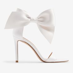 These Gorgeous Bridal Heels With A Classic Ankle Bow Detail Are The Perfect Statement Piece To Add To Your Look. Great For Your Wedding Or Other Special Occasions, These Will Have You Looking And Feeling Confident And Stylish. Features & Fabric Round Toe Sandals Strap Across The Toes Adjustable Ankle Closure; Bow Detail 4" Heel Padded Footbed Fabric/Metal Imported White Bow Heels, Fancy Event, Bridal Heels, Bow Sandals, Feeling Confident, Bow Heels, White Heels, White Bow, Toe Sandals