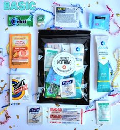 the contents of an emergency kit laid out on a white surface with confetti, toothpaste and other items