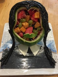 a carved watermelon with fruit in the shape of a heart