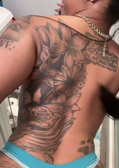 the back of a woman with tattoos on her body