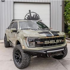 a truck parked in front of a garage door with the word sheryly on it