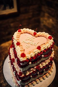 a heart shaped cake on a plate with the words happy birthday written on it