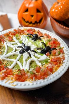 a white plate topped with food next to two pumpkins