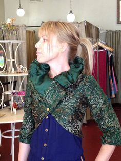 "Green brocade upside down jacket. Bolero style jacket where the lapels become the waist detail. Sleeves were taken out and put in the other direction. Standing color was the bottom of the previous jacket. Some tucks and seams here and there and many thoughtful moment. Construction concept from Junkie Styling. Fabric is chrysanthemum pattern in silk and cotton, lined.  Dramatic evening piece, you will be noticed when you walk into a room. Size - Small 14.5\" across upper back, 32\" under bust to Winter Brocade Outerwear With Long Sleeves, Long Sleeve Brocade Outerwear For Winter, Fall Brocade Long Sleeve Outerwear, Fall Long Sleeve Brocade Outerwear, Long Sleeve Brocade Outerwear For Fall, Fitted Brocade Outerwear For Fall, Costume Outerwear With Ruffles And Long Sleeves, Long Sleeve Ruffled Outerwear For Costume, Bolero Style