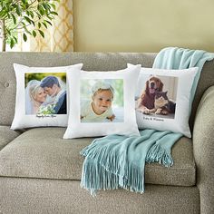 three pillows on a couch with pictures of two people and a dog