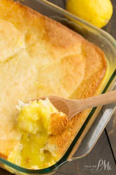 a close up of a casserole in a glass dish with a wooden spoon