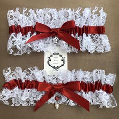 two red and white garters with ribbons tied around the edges are on display