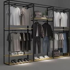 a clothing rack with clothes and shoes on it in a room that is lit up