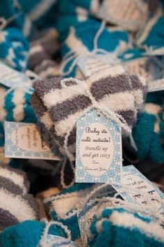 blue and gray striped knitted baby mittens for sale at a market stall in france