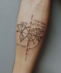 a person's arm with a tattoo on it that has a world map and arrows